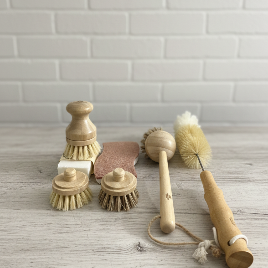 Set of wooden cleaning brushes on a wooden surface with a tiled wall background