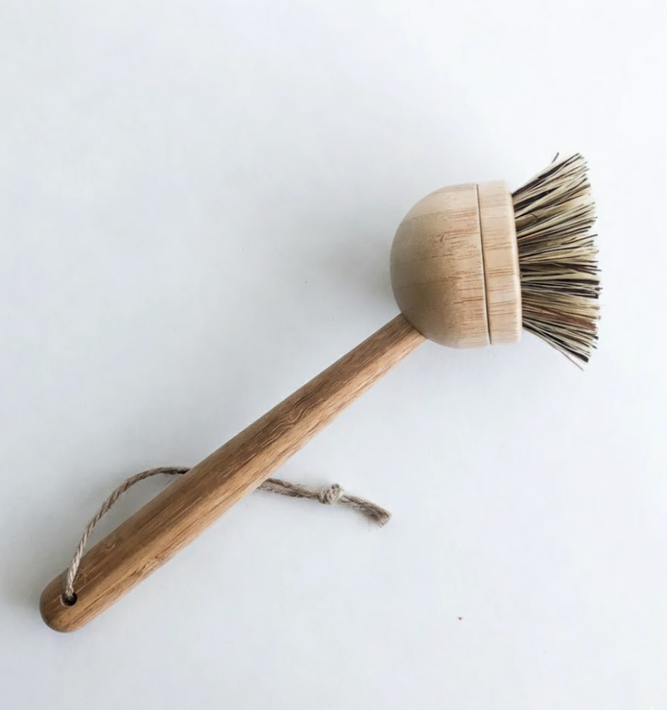 Wooden brush with bristle head on a white background