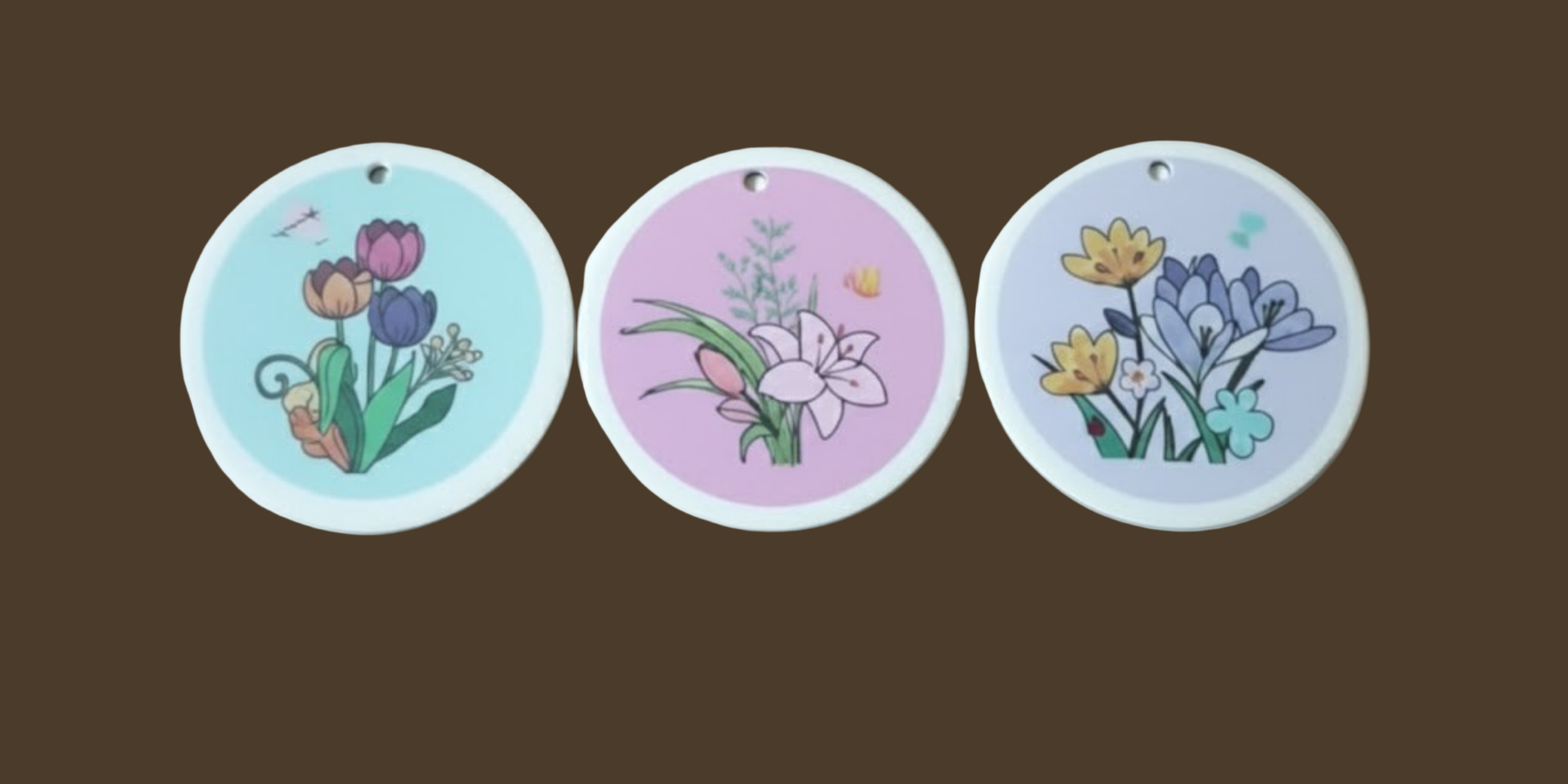 Three circular Dish Sponge with floral designs on a white background