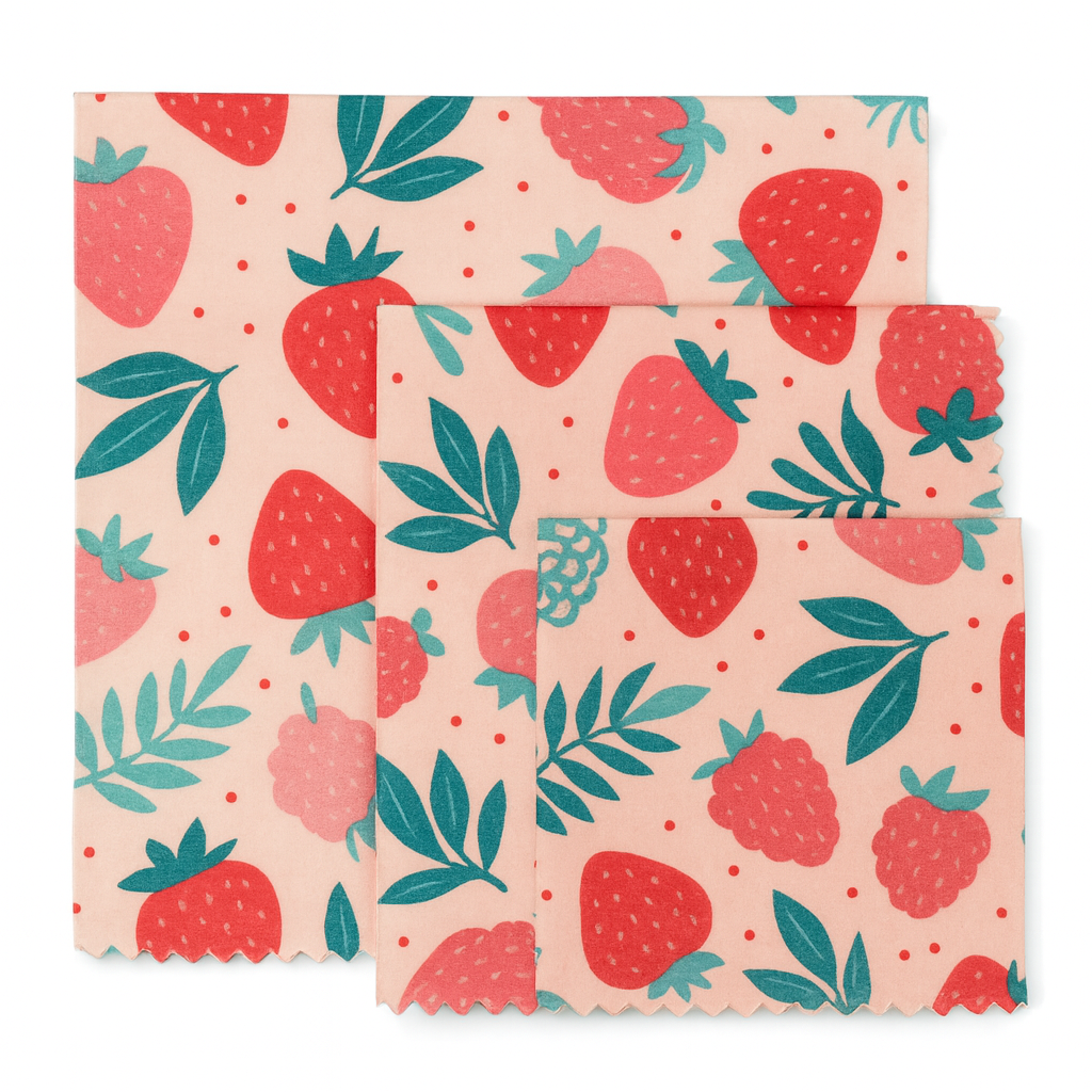 Set of three beewax wraps with strawberry pattern on a pink background