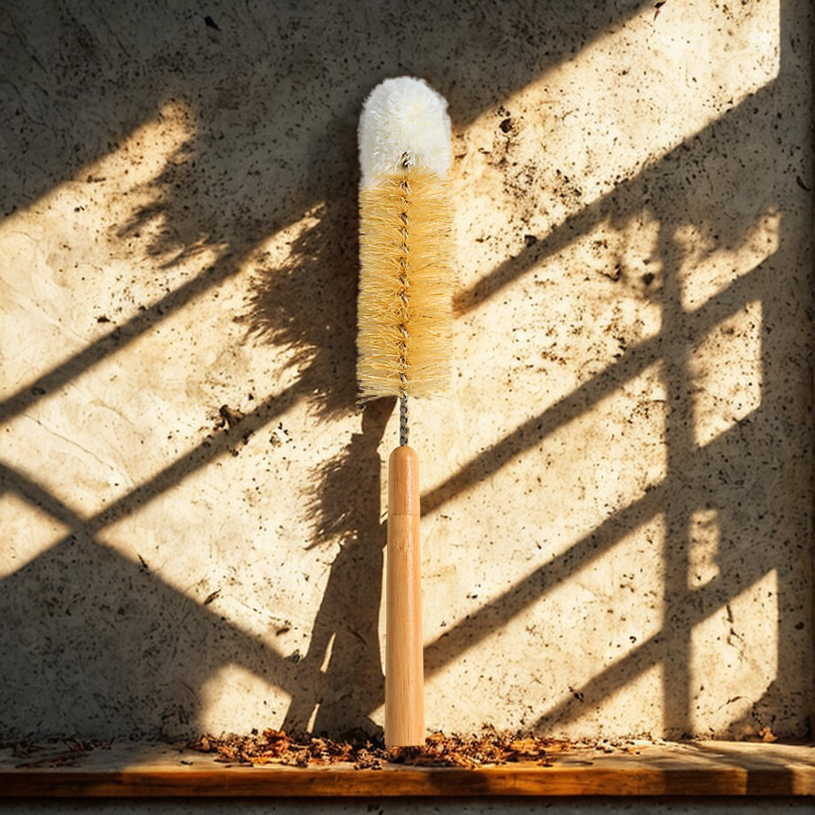 Bottle brush with wooden handle on a textured surface