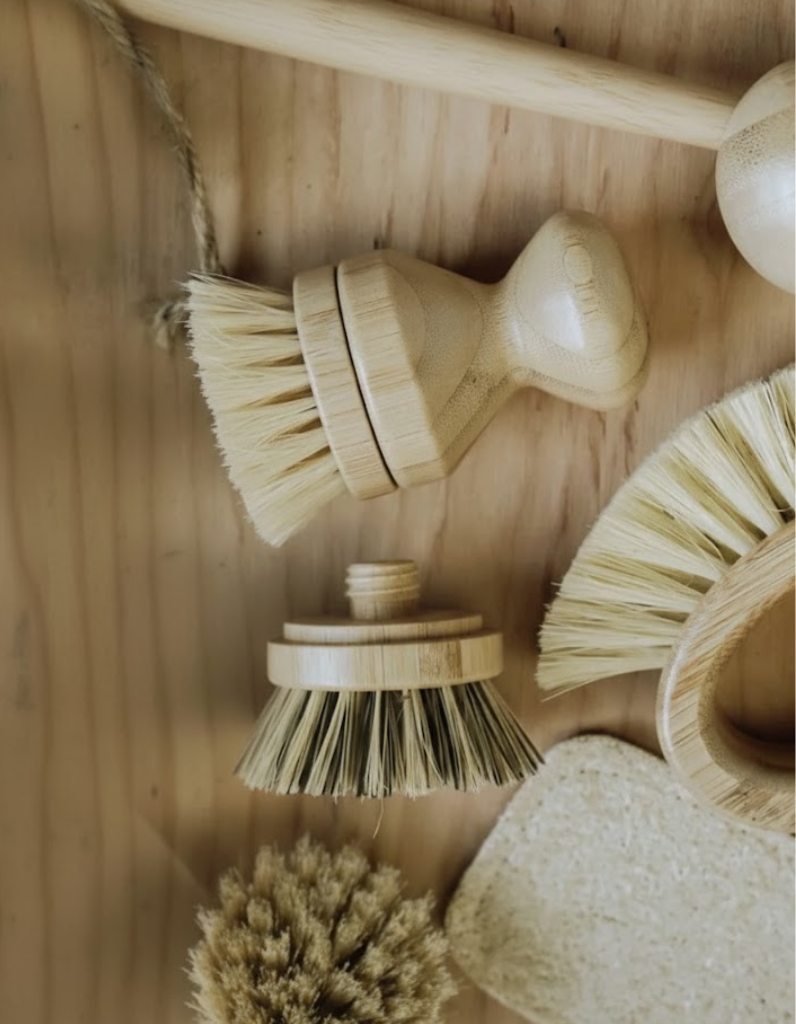 Set of natural cleaning brushes on a wooden surface