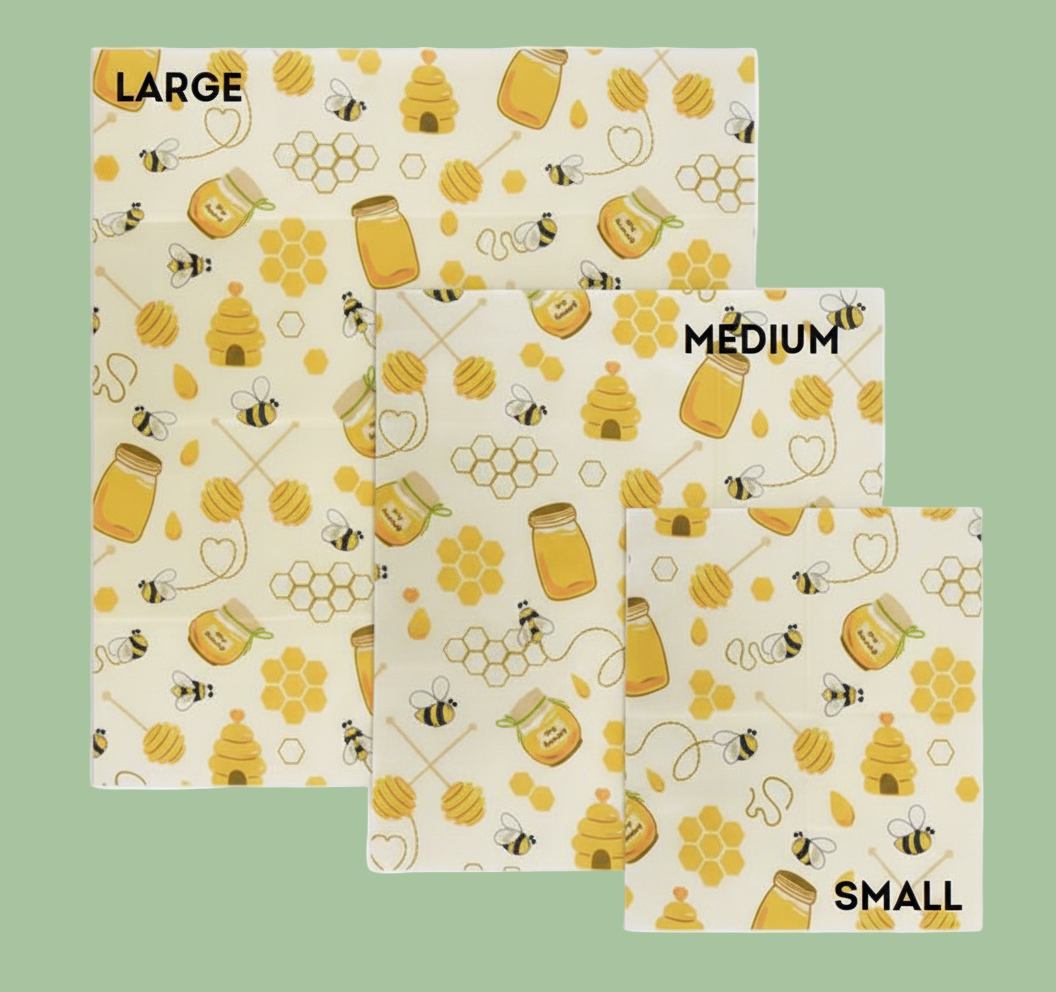 Three beeswax wraps with sizes (Large, Medium, Small) with a honeybee and honey pattern on a white background.