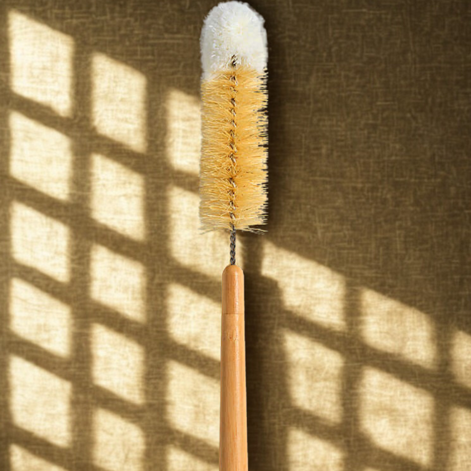 Cleaning brush with bristle head and wooden handle on a textured wall background