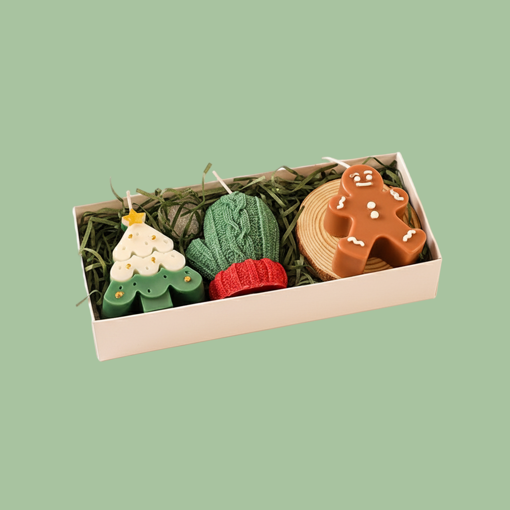 Set of Christmas-themed candles in a box with a white background